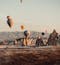Hot air ballons fly over Cappadocia's Fairy Chimneys as sunrise.